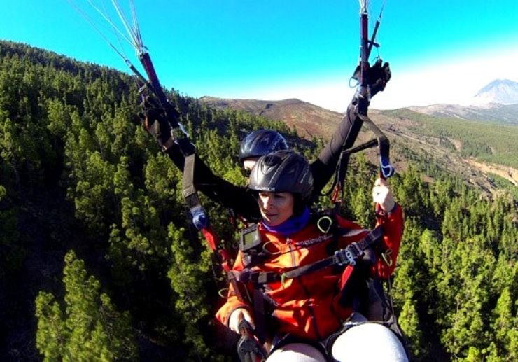 Paragliding over lush pines of Tenerife