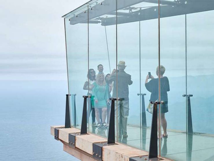 Tourists posing for photos on the glass floored of Abrante viewpoint